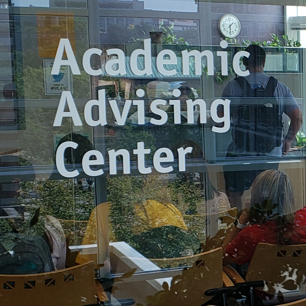 students sitting the the reception area of the Academic Advising Center